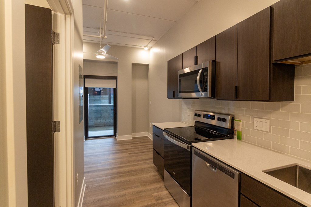 a kitchen with stainless steel appliances and wooden cabinets
