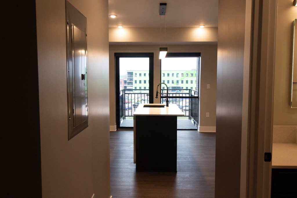 the view from the kitchen into the living room and the balcony