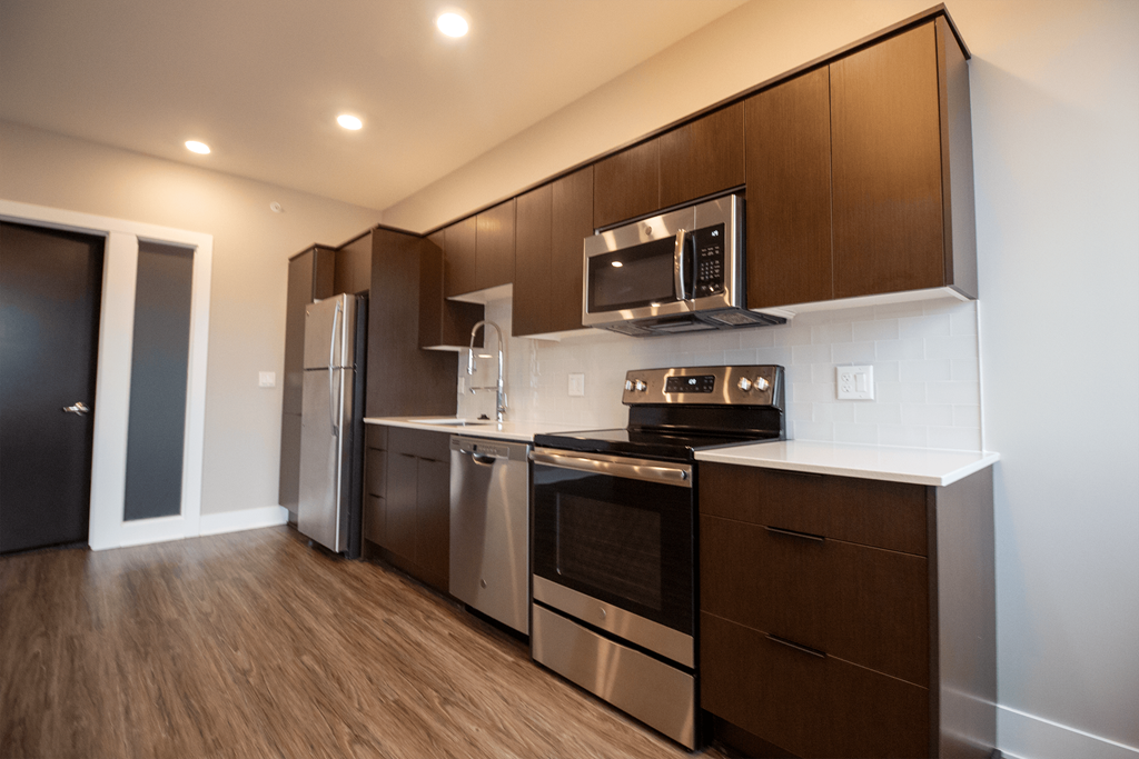 a kitchen with stainless steel appliances and wooden cabinets