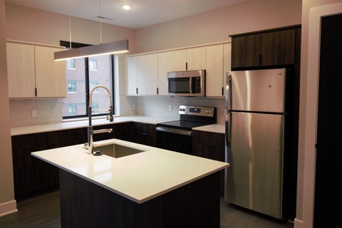 a kitchen with a sink and a refrigerator