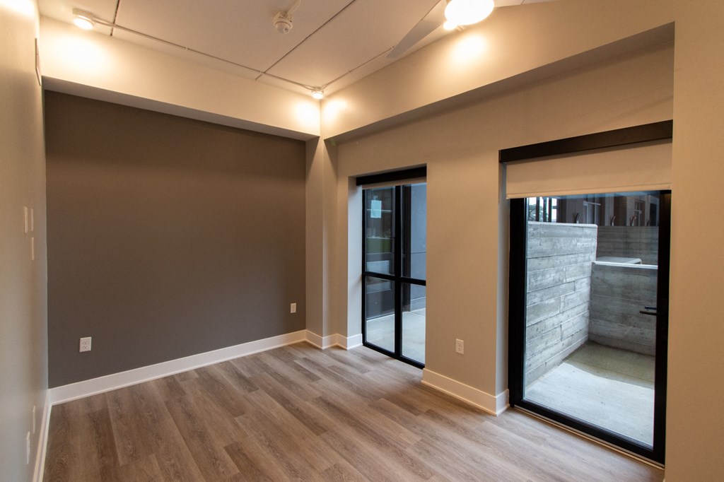 a living room with wood floors and a sliding glass door