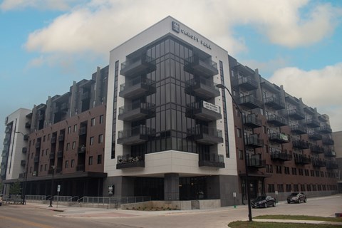 a large building with balconies on the side of a street