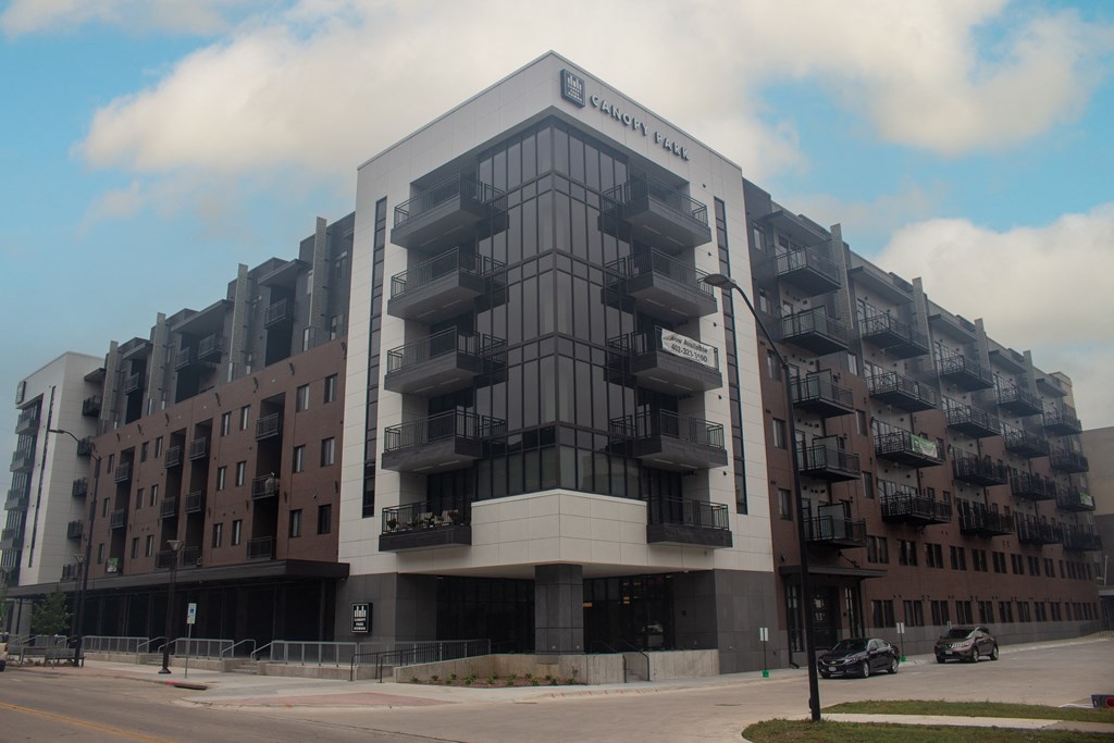 a large building with balconies on the side of a street