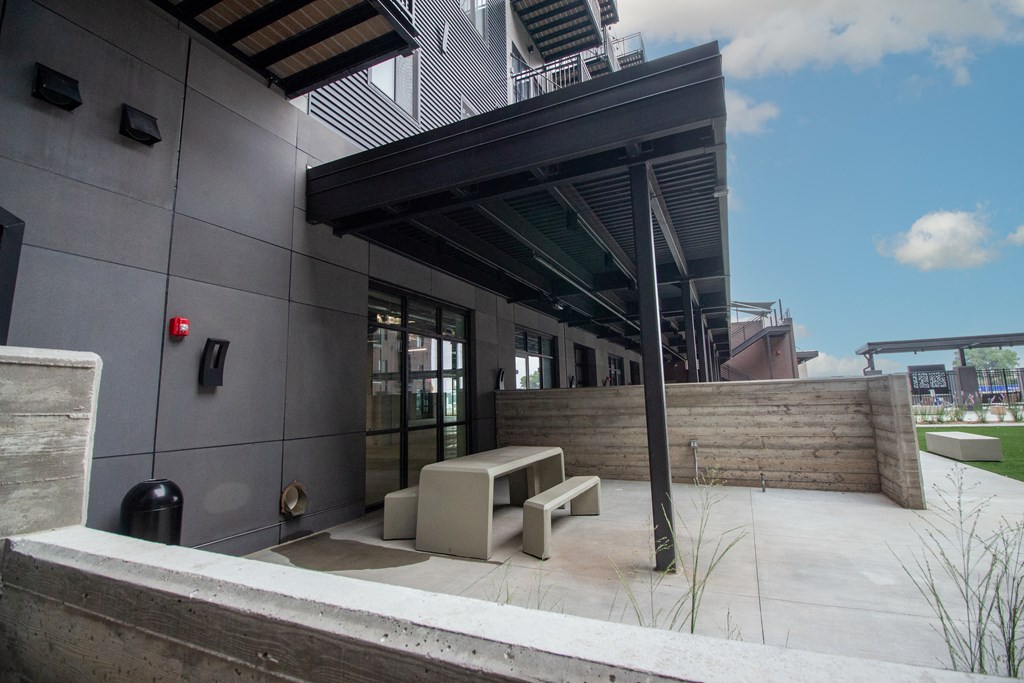 a large building with awning and benches in front of it