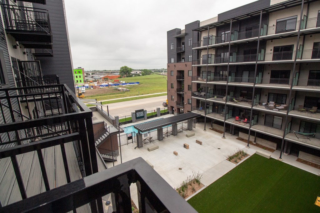 a view of the courtyard from the balcony of an apartment building
