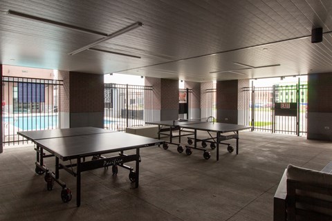 a large room with ping pong tables and a pool