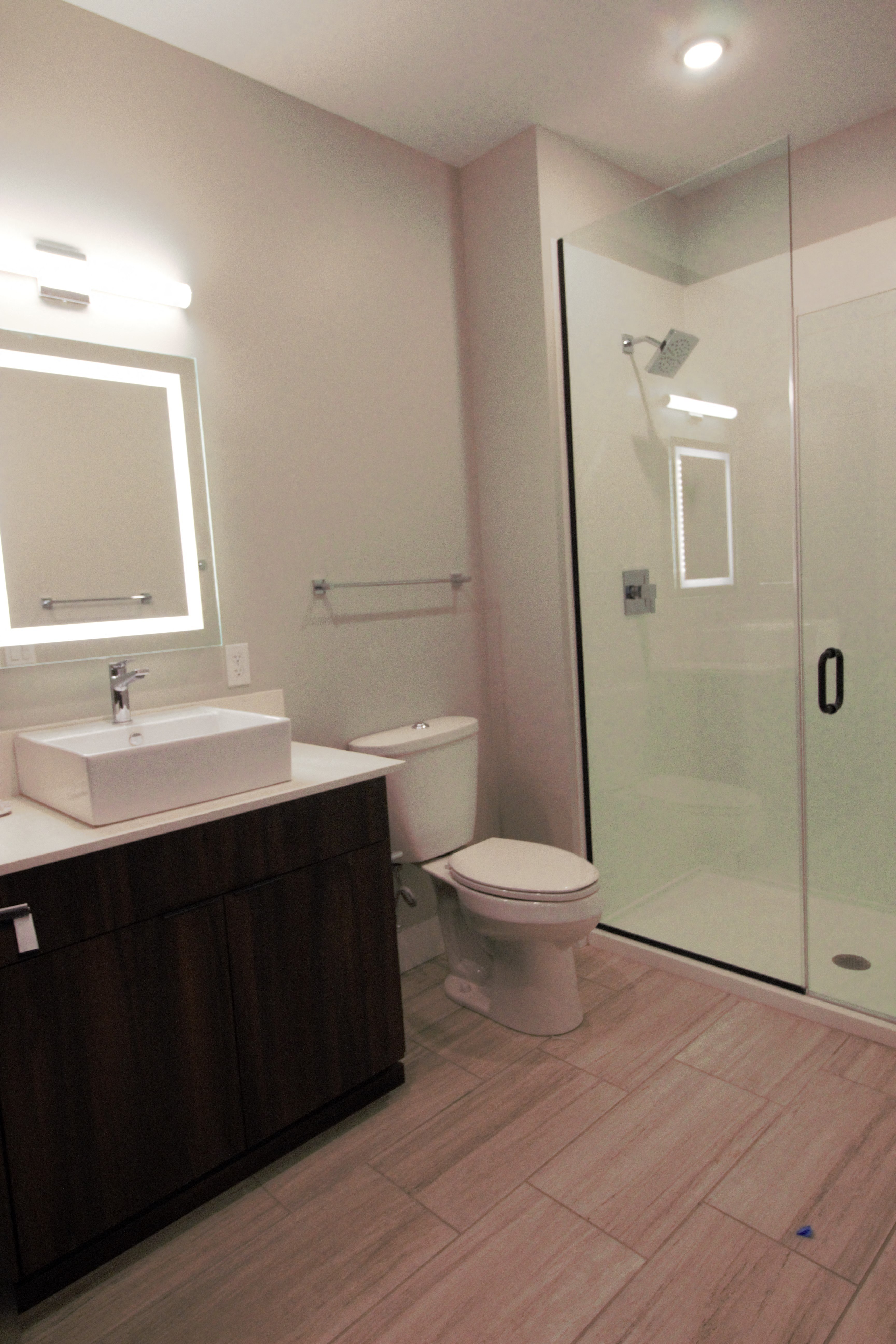 a small bathroom with a shower and a sink and a toilet