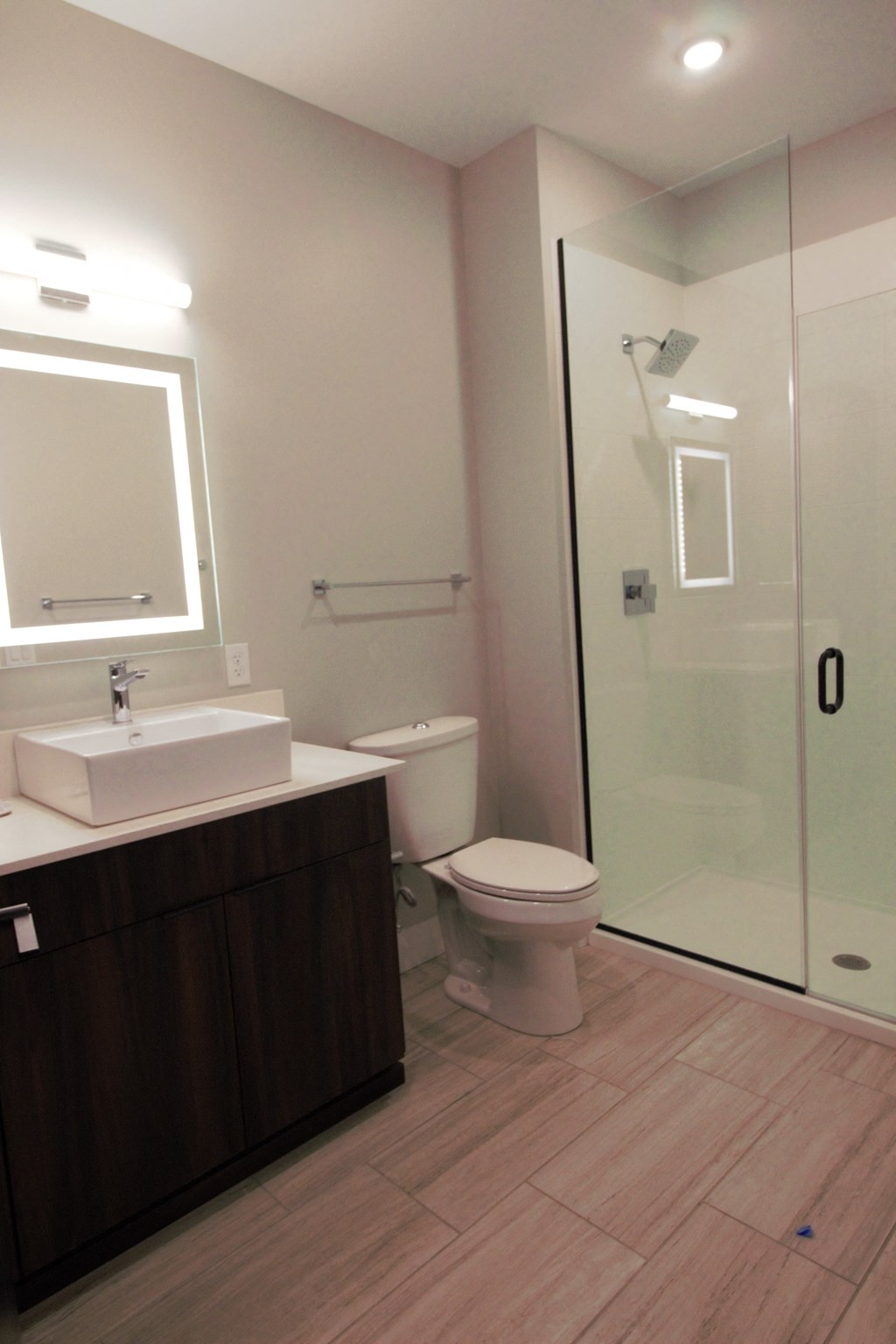 a small bathroom with a shower and a sink and a toilet