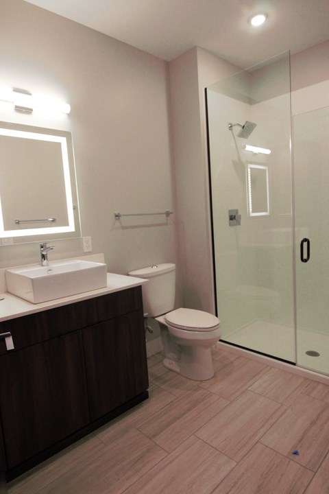 a small bathroom with a shower and a sink and a toilet