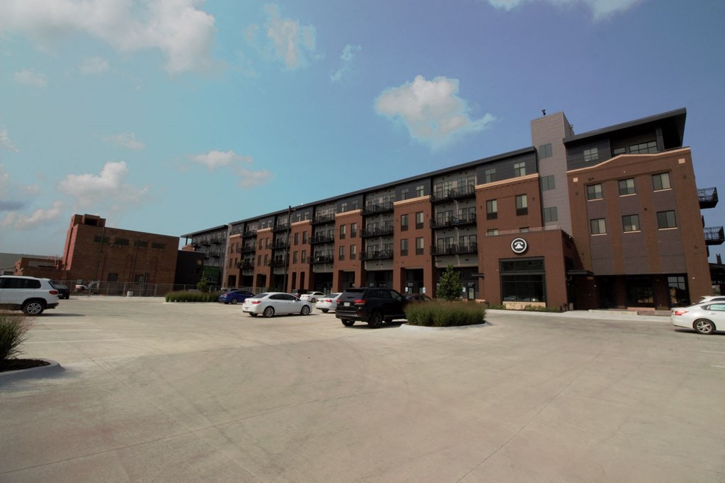 an empty parking lot in front of a large building