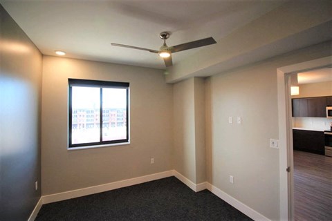 a living room with a ceiling fan and a window