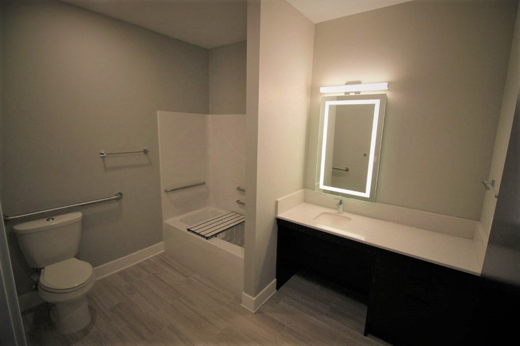 a bathroom with a toilet sink and a mirror