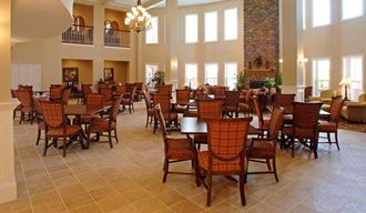 a large dining room with tables and chairs