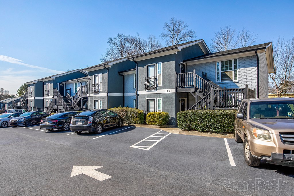 an apartment building with cars parked in front of it