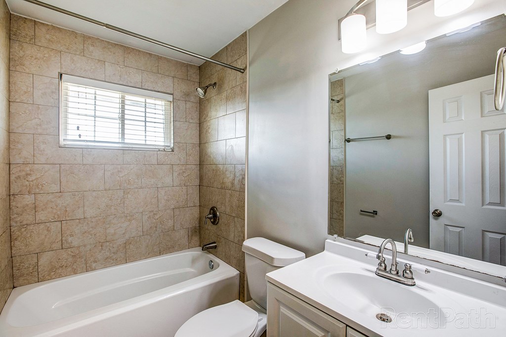a bathroom with a tub and a sink