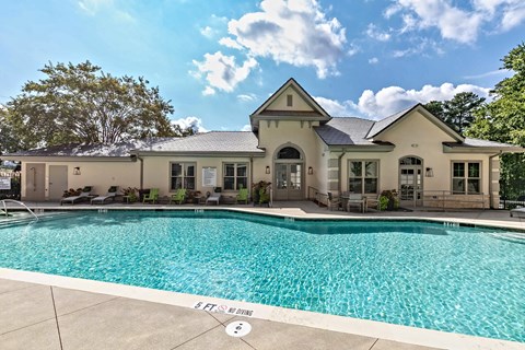 clubhouse with a pool in front.