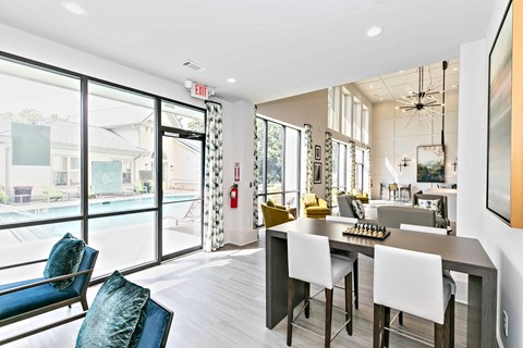 A modern kitchen with a dining table and chairs.