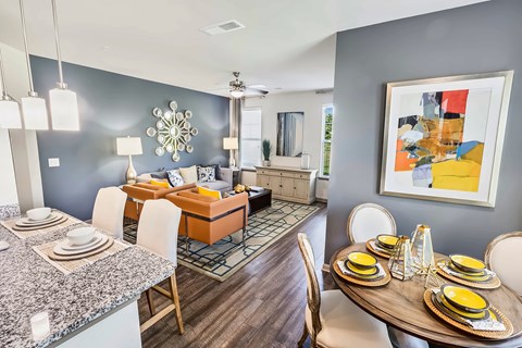 A modern dining room with a round table set for six.