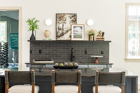 a dining room with a table and chairs in front of a black brick fireplace