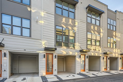 A modern building with garage doors and windows.