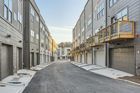 A long, narrow street with buildings on either side and a clear sky above.