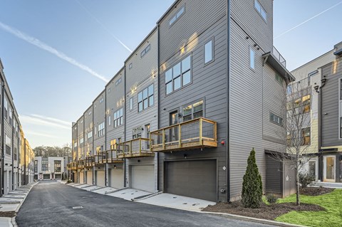 A street view of a residential area with modern buildings.