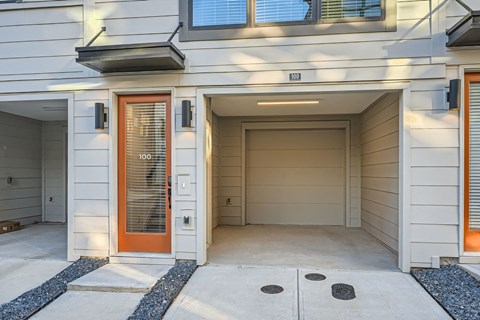 A modern house with a white exterior and a red door.