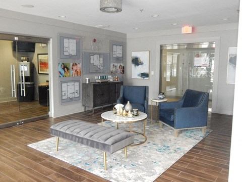 a living room with two blue chairs and a coffee table