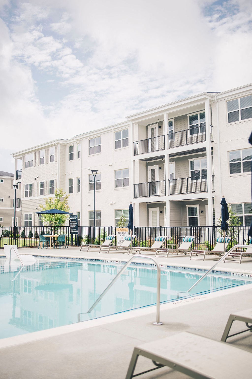 a swimming pool in front of an apartment building