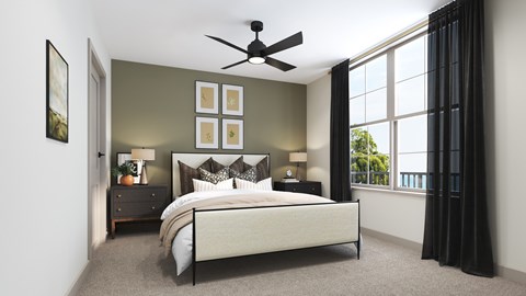 A bedroom with a large bed, a ceiling fan, and a window with black curtains.