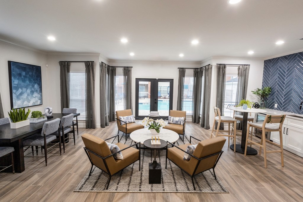 a living room with a table and chairs and a dining room