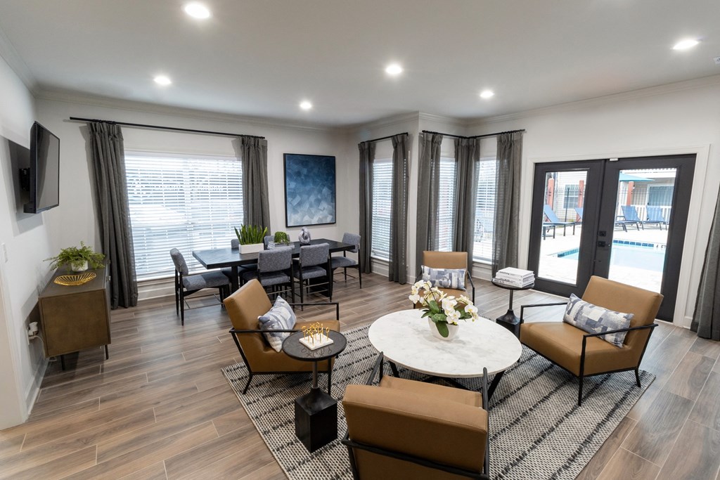 a living room with couches and chairs and a table