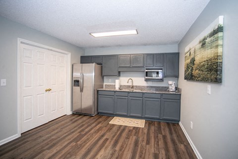 a kitchen with a stainless steel refrigerator and a counter top