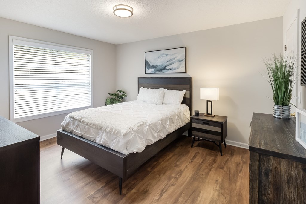 a bedroom with a large bed and a window
