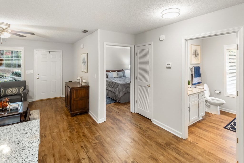 a bedroom with a bed and a bathroom with a toilet and a sink