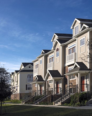 a row of townhomes on a sunny day with a blue sky - Photo Gallery 27