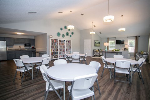 a dining room and kitchen with white tables and chairs