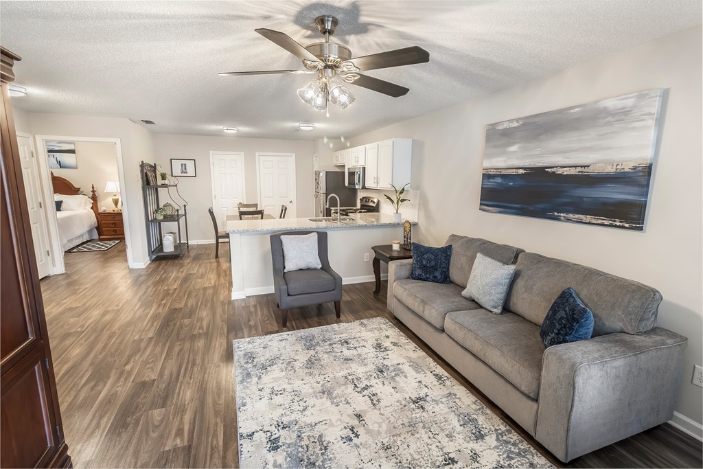 a living room with a couch and a ceiling fan