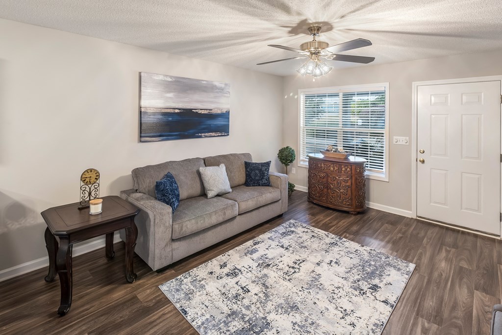 a living room with a couch and a ceiling fan