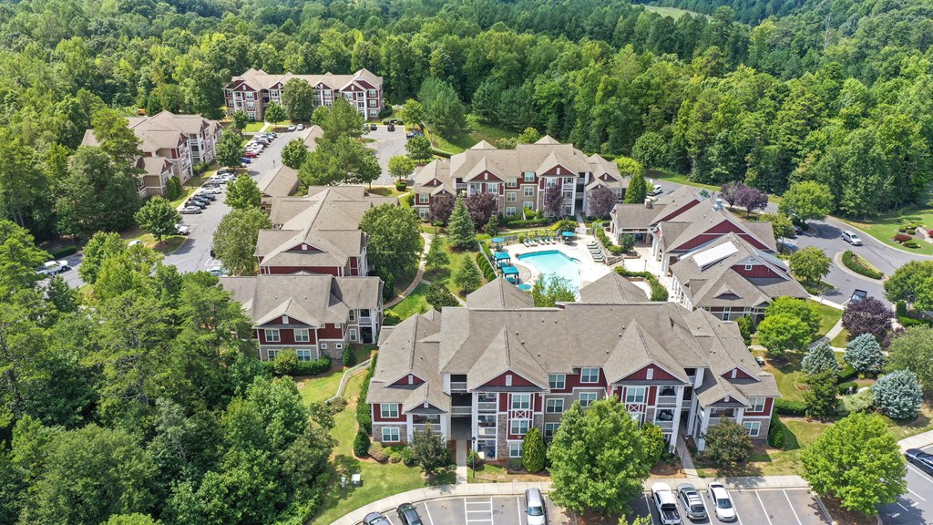 an aerial view of a neighborhood with houses and a swimming pool