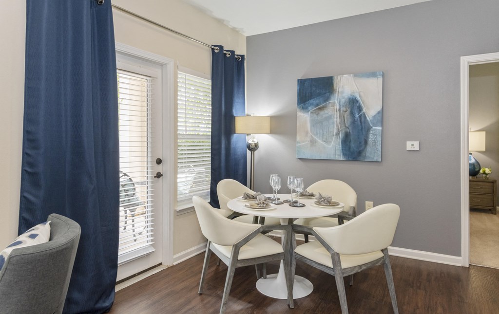 a dining room with a table and chairs and a window