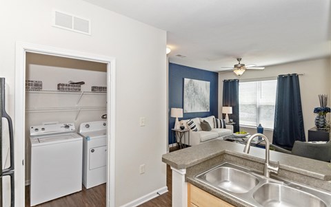 the view of a kitchen and living room with a stove refrigerator and sink