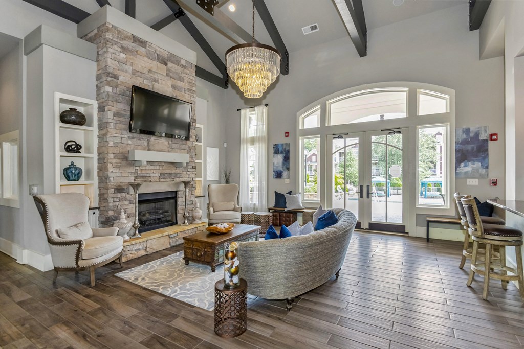the living room has a large stone fireplace and a large window