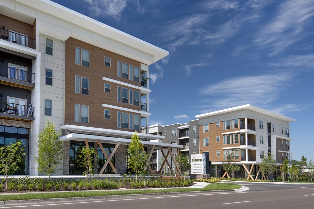 a rendering of an apartment building with a street in front of it