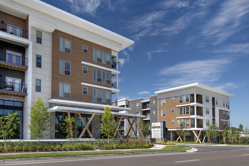a rendering of an apartment building with a street in front of it - Photo Gallery
