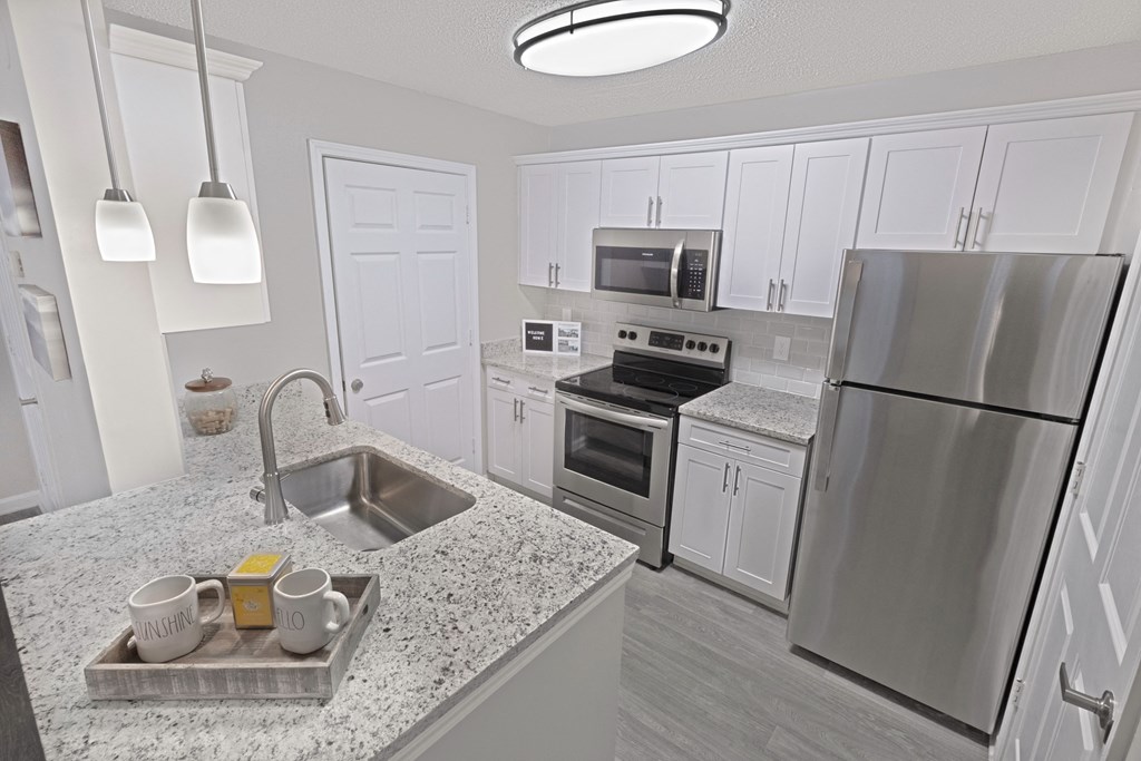 model kitchen with island and stainless steel appliance package at The Carlyle at Perimeter, Dunwoody, GA, 30338