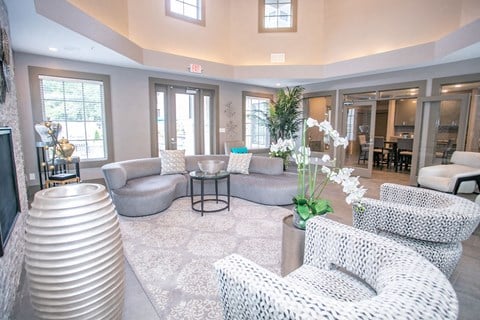 a living room with couches and chairs and a table