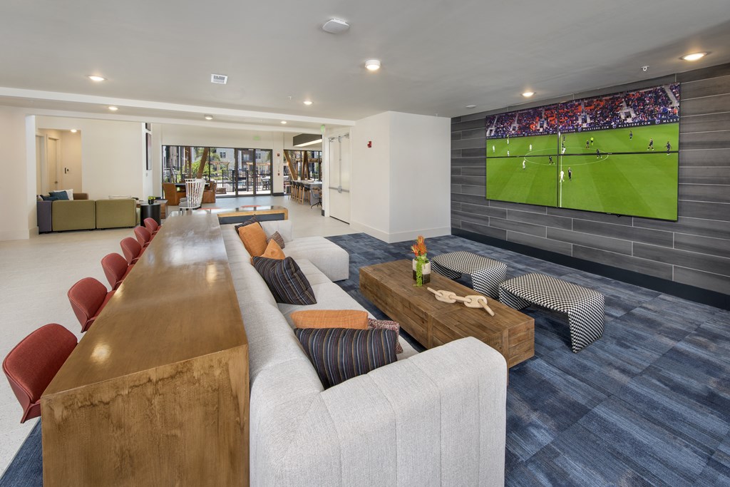 a living room filled with furniture and a flat screen tv