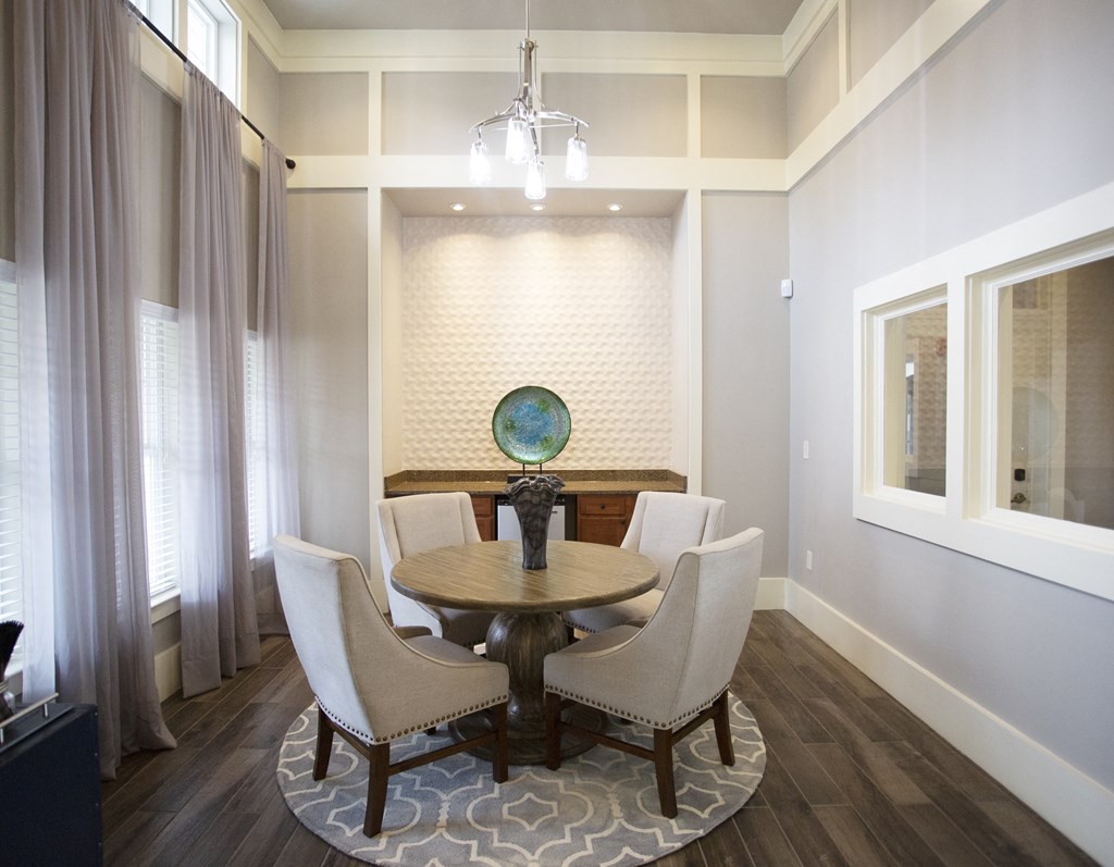 a dining room with a table and chairs