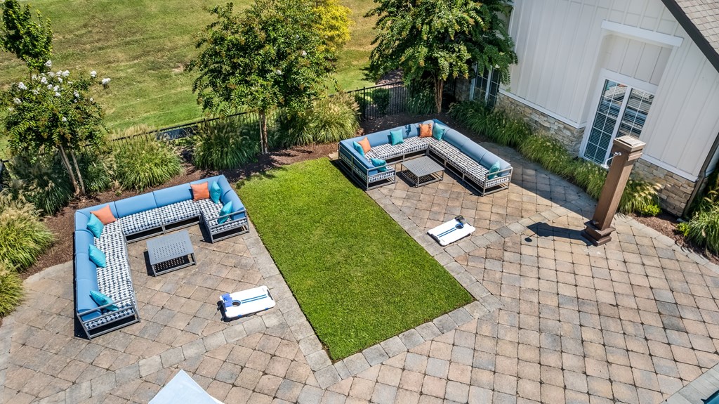 A patio with a blue and orange couch.